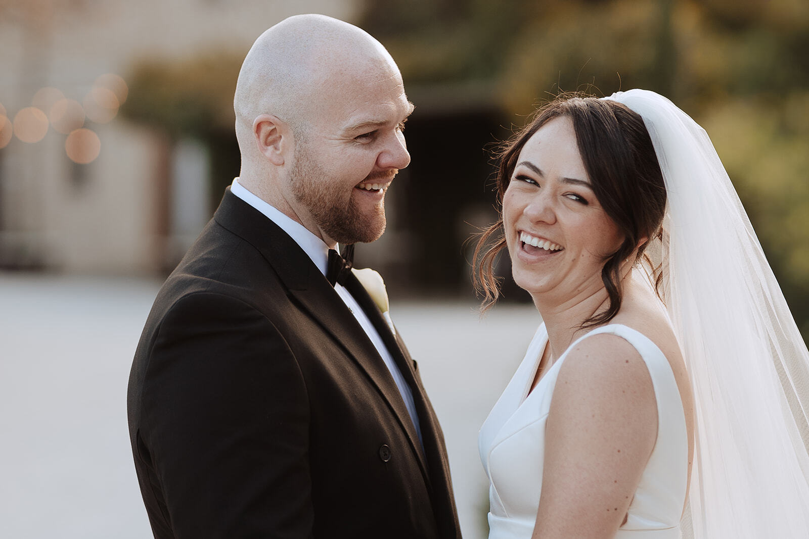 Rebecca e Hugh ridono durante un ritratto di coppia all’aperto a Borgo di Tragliata.